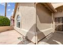 Exterior angle view of house with stucco siding and an arched window at 1560 E Riviera Dr, Chandler, AZ 85249