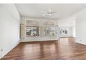 Bright living room with wood floors, ceiling fan, and many windows at 1560 E Riviera Dr, Chandler, AZ 85249