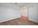 Empty bedroom with wood-look tile flooring and large window at 26367 S 231St Way, Queen Creek, AZ 85142