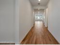 Bright hallway with wood-look tile flooring at 26367 S 231St Way, Queen Creek, AZ 85142