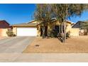 Front view of a single-story house with a white garage door at 12640 W Florence St, Avondale, AZ 85323