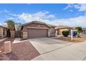 Charming one-story home with a front yard and two-car garage at 15829 W Carmen Dr, Surprise, AZ 85374