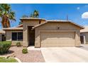 Inviting single-Gathering home showcasing a desert landscape, private entrance, and attached garage at 1778 S Saddle St, Gilbert, AZ 85233