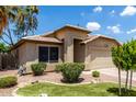 Well-maintained property featuring neat landscaping, desert accents, and an attached two-car garage at 1778 S Saddle St, Gilbert, AZ 85233