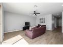 Spacious living area with two sofas and a flat-screen TV at 35907 W San Clemente Ave, Maricopa, AZ 85138