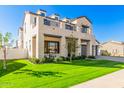 Modern two-story house with stone facade, balcony, and neatly manicured lawn at 3901 E Sagebrush St, Gilbert, AZ 85296