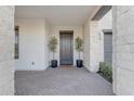 Modern front entrance with dark gray door and potted plants at 3901 E Sagebrush St, Gilbert, AZ 85296