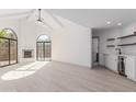 Bright living room with wood-look tile flooring, fireplace, and bar area with wine fridge at 7955 E Chaparral Rd # 103, Scottsdale, AZ 85250