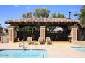 Covered patio and seating area near the pool at 7955 E Chaparral Rd # 103, Scottsdale, AZ 85250