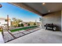 Covered patio with built-in grill, artificial turf, and stone patio at 824 E Monte Way, Phoenix, AZ 85042