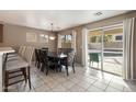 Bright dining room with sliding glass doors opening to the backyard and pool at 1041 W Chilton Ave, Gilbert, AZ 85233