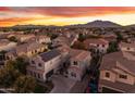 Luxury home with solar panels, stunning sunset views, and mountain backdrop at 3121 E Powell Way, Gilbert, AZ 85298