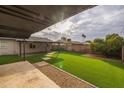 Landscaped backyard with artificial turf and covered patio at 114 W Ivanhoe Pl, Chandler, AZ 85225