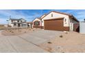 New construction home with brown garage door and driveway at 7280 E White Tail Rd, San Tan Valley, AZ 85143