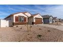 New construction home with desert landscaping and two-car garage at 7280 E White Tail Rd, San Tan Valley, AZ 85143