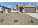Inviting single-story home with neutral exterior, desert landscaping, and a two-car garage at 16072 W Prickly Pear Trl, Surprise, AZ 85387