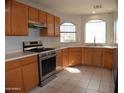 Spacious kitchen with stainless steel appliances and wood cabinets at 17134 N Eureka Trl, Surprise, AZ 85374