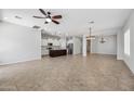 Open concept living area with tile floors and a kitchen island at 10605 E Monterey Ave, Mesa, AZ 85209