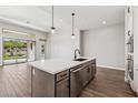 Kitchen island with stainless steel appliances and quartz countertops at 32962 N 131St Dr, Peoria, AZ 85383
