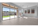 Sunlit living room featuring large sliding doors, neutral tones, and backyard views at 32994 N 131St Dr, Peoria, AZ 85383