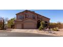 Inviting two-story home boasts a spacious three-car garage and desert landscaping at 3650 N Barron --, Mesa, AZ 85207