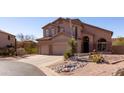 Inviting two-story home boasts a spacious three-car garage and desert landscaping at 3650 N Barron --, Mesa, AZ 85207