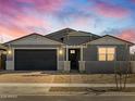 Attractive gray house with a dark garage door and landscaping at 4045 S 177Th Ln, Goodyear, AZ 85338