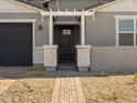 Modern house entrance with a metal gate and brick columns at 4045 S 177Th Ln, Goodyear, AZ 85338