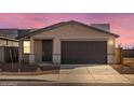 New construction home with a dark brown garage door and stone accents at 9109 N 173Rd Ln, Waddell, AZ 85355