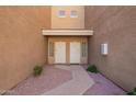 A front entrance showing two front doors to the units with stone gravel, and pavers leading to each door at 1335 E June St # 239, Mesa, AZ 85203