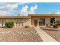 Tan single story home with landscaped yard and walkway at 13428 N Hawthorn Dr, Sun City, AZ 85351