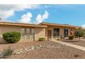 Tan single story home with landscaped yard and walkway at 13428 N Hawthorn Dr, Sun City, AZ 85351