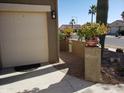 Tan two-car garage with decorative pots and a paved walkway at 2630 E San Mateo Dr, Casa Grande, AZ 85194