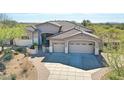 Stunning home featuring a spacious three-car garage and desert landscaping at 3701 E Sat Nam Way, Cave Creek, AZ 85331