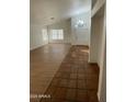 Open living room and entryway with tile and wood-look floors at 7504 W Jenan Dr, Peoria, AZ 85345