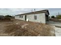 Side view showcasing the home's stucco exterior and landscaping at 11474 N 79Th Dr, Peoria, AZ 85345