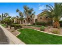 Charming home featuring mature landscaping, stone accents, and a well-maintained lawn, enhancing the overall aesthetic at 2121 N Orchard --, Mesa, AZ 85213