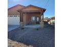 Newly built tan house with covered porch and small front yard at 5647 E Calle Pitaya --, Guadalupe, AZ 85283