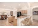 Kitchen with island, breakfast bar, and light wood cabinets at 9510 E Jadecrest Dr, Sun Lakes, AZ 85248