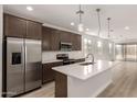 Modern kitchen boasts stainless steel appliances, white countertops and island with pendant lighting at 18544 E Dario Rd, Gold Canyon, AZ 85118