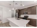 Contemporary kitchen features quartz countertops, a large island, and stainless steel appliances at 18544 E Dario Rd, Gold Canyon, AZ 85118