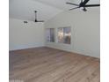 Spacious living room with hardwood floors, ceiling fan, and natural light from windows at 9209 E Emerald Dr, Sun Lakes, AZ 85248