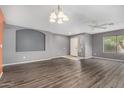 Living room with hardwood floors, recessed lighting and neutral color palette throughout at 15912 W Marconi Ave, Surprise, AZ 85374