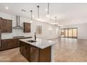 Bright, modern kitchen featuring a center island, sleek stainless-steel appliances, and an open floor plan at 17586 W Blue Sky Dr, Surprise, AZ 85387