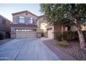 Two-story house with a welcoming front porch and attached two-car garage at 23914 N 25Th Way, Phoenix, AZ 85024