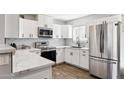 Modern white kitchen with stainless steel appliances at 4315 E Nancy Ln, Phoenix, AZ 85042