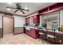 Bright kitchen with red cabinets, a farmhouse sink, and ample counter space at 6255 E Ensenada St, Mesa, AZ 85205