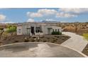 Modern home with stone exterior and circular driveway at 17213 E Morning Vista Ct, Rio Verde, AZ 85263