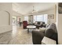 Open-concept living room filled with natural light, tile floors, and comfortable seating at 17317 N Ponca Way, Surprise, AZ 85374