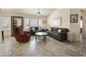 Inviting living room with neutral tones, plush seating, tile floors, and bright natural light at 17317 N Ponca Way, Surprise, AZ 85374